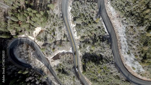 Switchback road with cars driving on Highway 89 A in Sedona, Arizona with drone video overhead moving down. photo