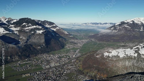 Fronalpstock Glarus Switzerland view of amazing village in Alps with clouds low between mountains photo