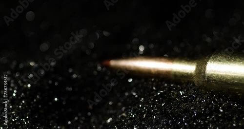 Aerodynamic Bullets Of 6mm ARC Heap Over Glistening Grains Of Gunpowder. Slow Motion Shot photo