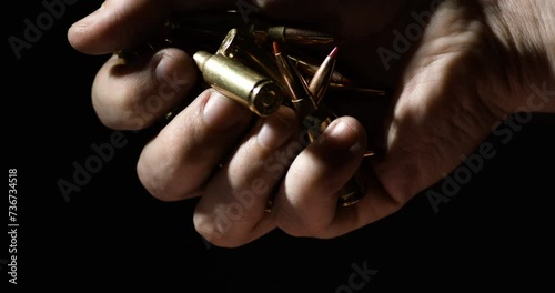 .300 AAC Blackout Plastic Tipped Falling From Hand Of Man. - close up, slow motion photo