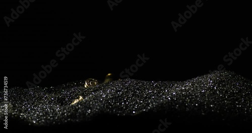 Gunpowder dust with 9×19mm Parabellum bullet falling over, detail macro shot photo