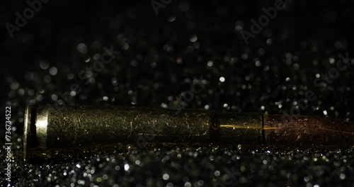 300 AAC Blackout Intermediate Cartridge Falling Into Pile Over Black Bullet Grains. Selective Focus Shot photo