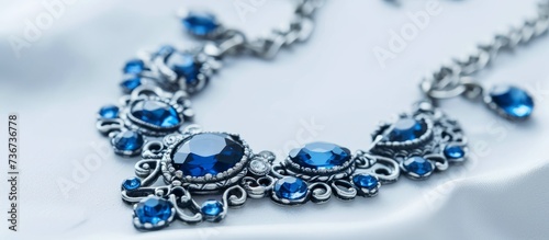 A close up of body jewelry featuring azure and electric blue stones made from natural materials on a white surface, showcasing creative art in the form of a unique necklace design