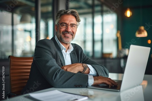 Smiling mature business man of middle age, confident entrepreneur or bank manager, 50 years old executive, mid aged businessman investor trader, male lawyer sitting at work desk, Generative AI