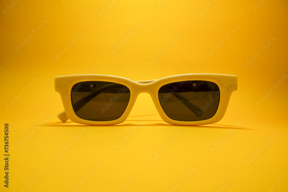 Hipster eyeglasses in pastel frames on a yellow background. Stylish eyeglasses. Retro fashion bold frame style. Space for text. Hipster eyeglasses in pastel frames on a yellow background. Stylish eyeglasses. Retro fashion bold frame style. Space for text.