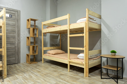 Wooden bunk bed , desk in large hostel room