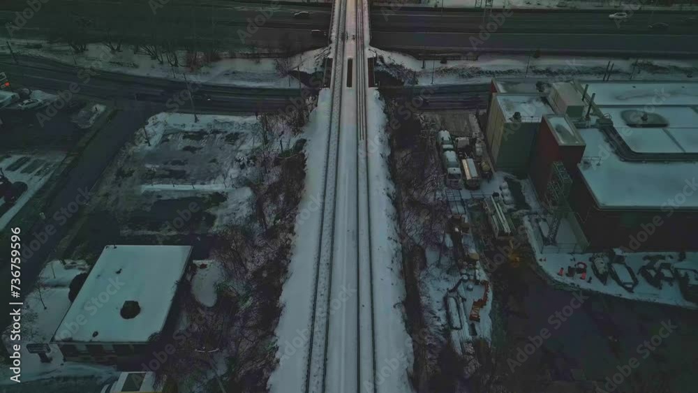 Longueuil, Canada - Jan 26 2024: Drone film of Railway Bridge across the Saint-Laurent River during sun set Longueuil, Canada - Jan 26 2024: Drone film of Railway Bridge across the Saint-Laurent River during sun set