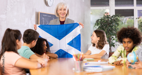 in geography lesson, elderly teacher very eloquently tells children about history of ancient scotland