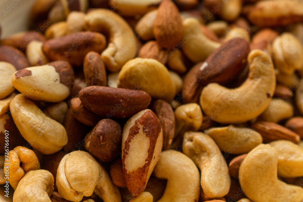 Heap of Brazil nuts, cashews and almonds in a bowl Heap of Brazil nuts, cashews and almonds in a bowl