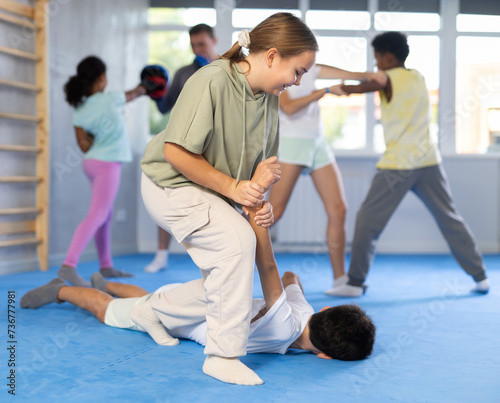 Self-defense - girl twists the arm of an attacking boy during self-defense training
