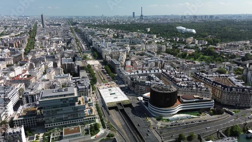 Sacem building with Louis Vuitton foundation and Tour Eiffel in background, Paris cityscape, France. Aerial sideways photo