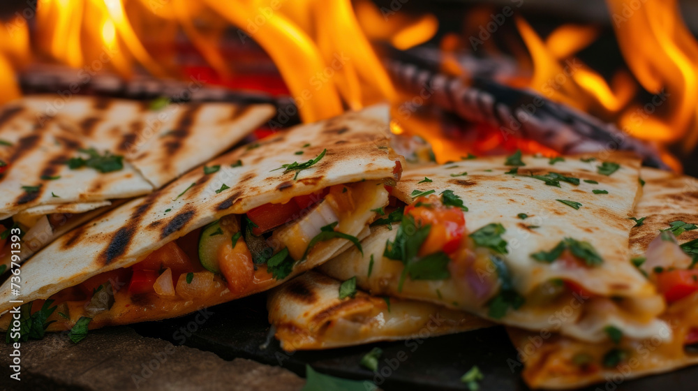 Flames lick at the edges of the quesadillas caramelizing the cheese and vegetables inside and adding a touch of e to every bite.