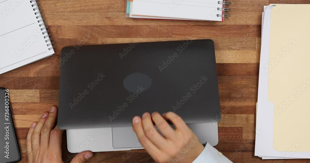 Man freelancer puts laptop on table and starts to type Man freelancer puts laptop on table and starts to type