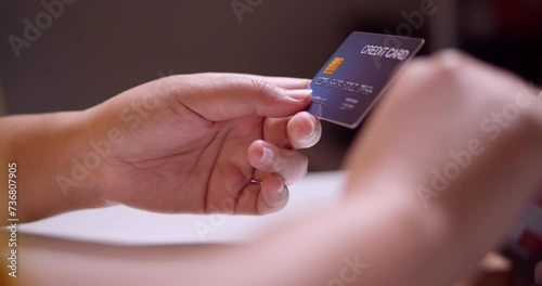 Encoding the details of a credit card that the owner is holding on an online application to complete a transaction.