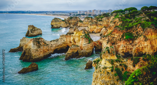 Panoramic view of the Algarve's rocky coastline, where cliffs meet the crashing waves of the Atlantic Ocean.