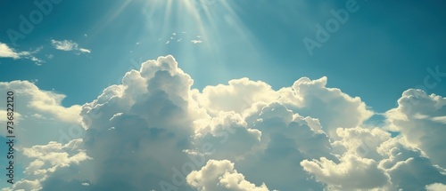 the sun shines through the clouds in a blue sky with white fluffy clouds in the foreground and a blue sky with white fluffy clouds in the foreground. photo