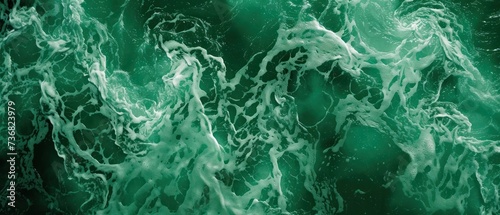 a close up of a green and white background with water swirling in the middle of the image and the top part of the image in the bottom right corner of the frame.