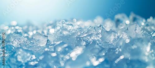 Close up of freezing water as ice cubes on an electric blue background  resembling a fashion accessory. The transparent material sparkles like the winter sky  creating a stunning visual for any event