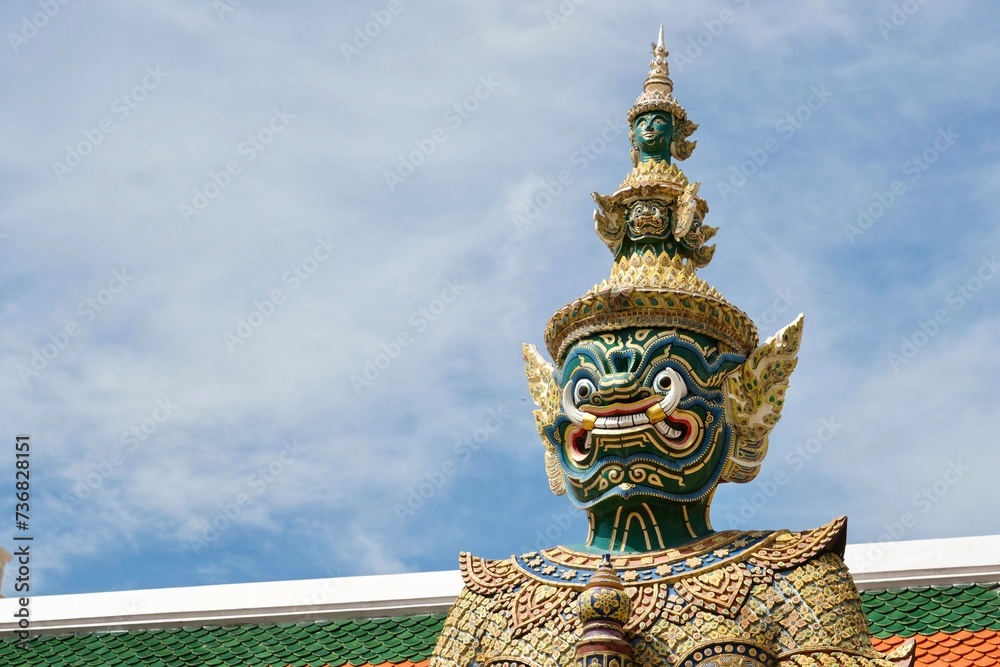 Close-up of Thotsakan, one of two giant statues - characters from the Ramakien epic - guarding the rear Koei Sadet Gate of the Wat Phra Kaew or Temple of the Emerald Buddha in Bangkok, Thailand 