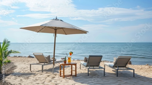 Two wooden beach chairs under an umbrella with a refreshing cocktail, overlooking a sunny seascape. Perfect for vacation and leisure concepts. © mashimara