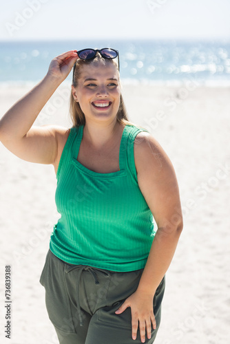 Young plus size Caucasian woman enjoys a sunny day at the beach