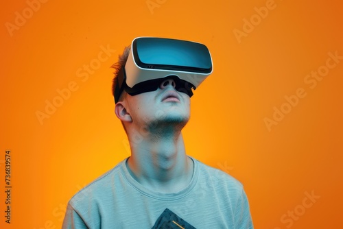 Young man wearing virtual reality goggles. © kardaska