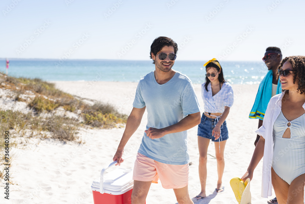 Fototapeta premium A diverse group of friends enjoys a sunny day at the beach