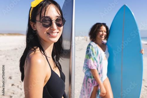 Young biracial women enjoy a sunny beach day