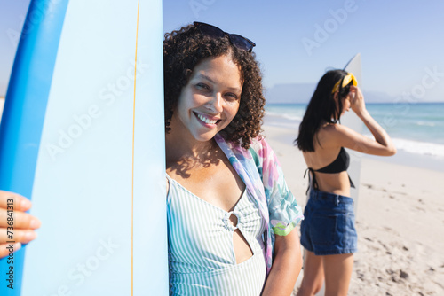 Biracial women enjoy a sunny beach day
