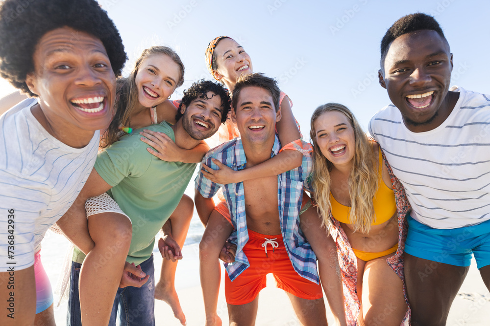 Fototapeta premium Diverse group of friends enjoy a day at the beach