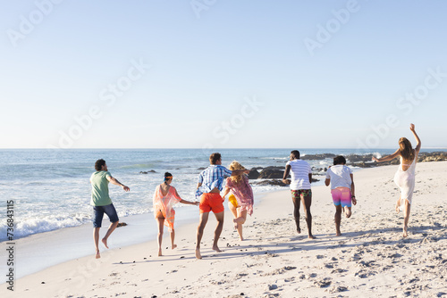 Diverse group of friends enjoy a day at the beach