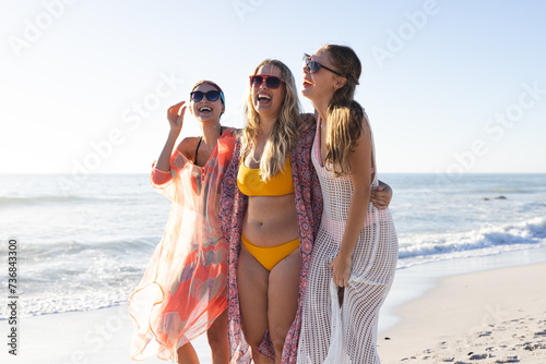 Three young women enjoy a sunny beach day