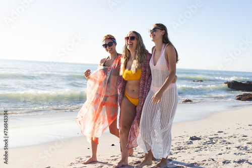 Three young women enjoy a sunny beach day
