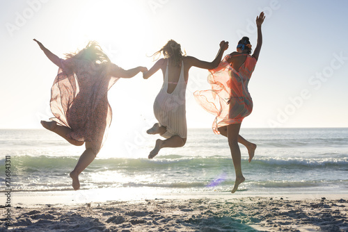 Three joyful friends enjoy a beach outing