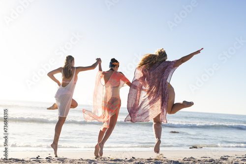 Three women enjoy a carefree moment on the beach