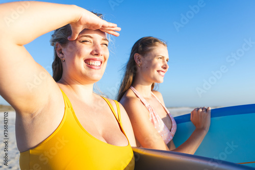 Two young Caucasian women enjoy a sunny beach day