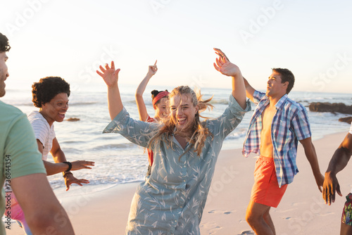Friends enjoy a lively beach party at sunset