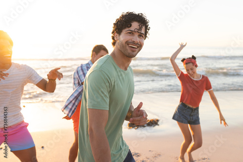 Young Caucasian man enjoys a beach outing with friends