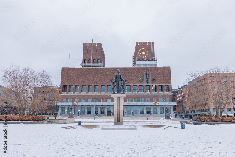 View of the Oslo Radhuset or town hall in the midst of a winter, looking fromt he harbour towards the west side. Towers of town hall in renovation.