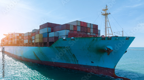 front view Cargo Container ship in the ocean ship carrying container and running for import export concept technology freight shipping by ship