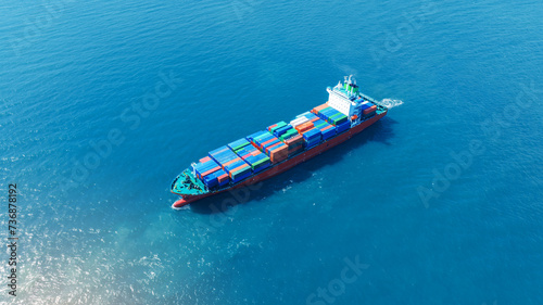top view Cargo Container ship with contrail in the ocean ship carrying container and running for import export concept technology freight shipping by ship