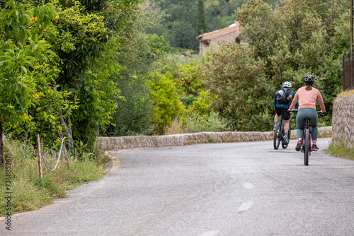 two cyclists on the road, Fornalutx, Soller valley route, Mallorca, Balearic Islands, Spain