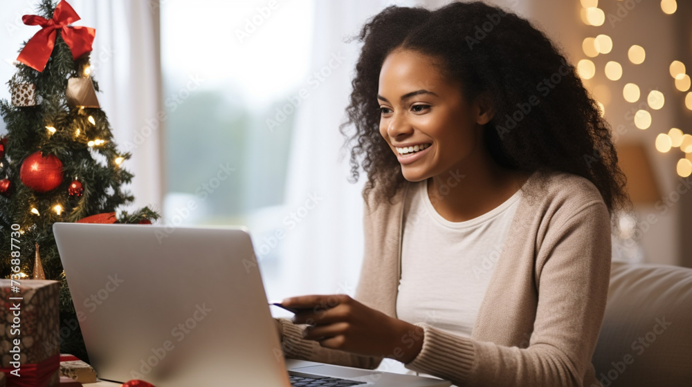 Smiling young African woman shopping online. Laptop, credit card. Spending money concept. Surfing internet shopping online via laptop Smiling young African woman shopping online. Laptop, credit card. Spending money concept. Surfing internet shopping online via laptop