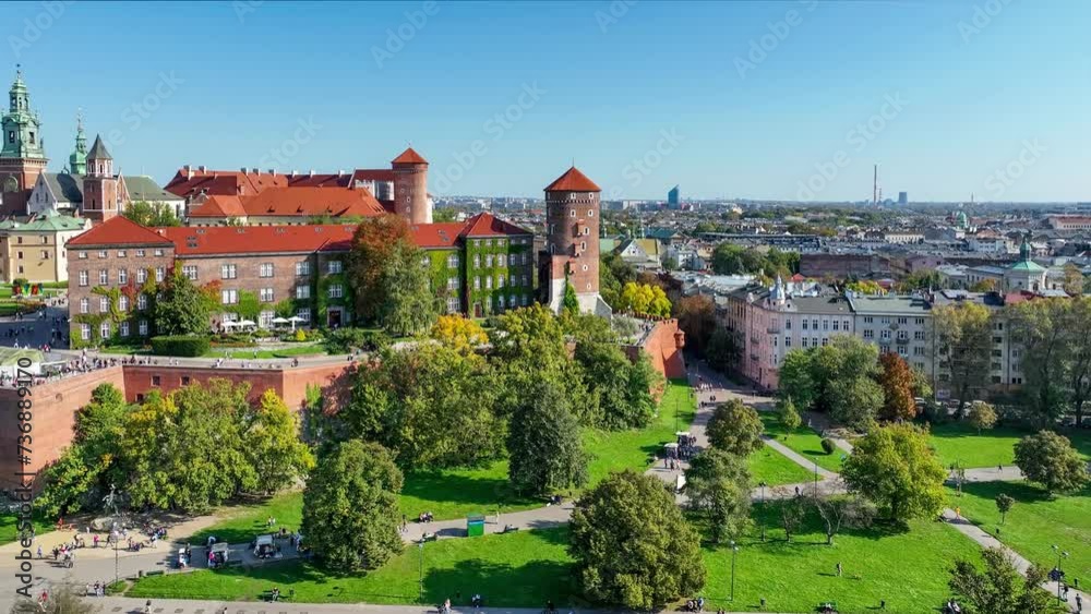 Royal Wawel Gothic Cathedral and castle and in Krakow, Poland. Curtain walls, towers, park and boulevards with tourists and bikers along Vistula river with small harbor and boats. Aerial 4K video Royal Wawel Gothic Cathedral and castle and in Krakow, Poland. Curtain walls, towers, park and boulevards with tourists and bikers along Vistula river with small harbor and boats. Aerial 4K video