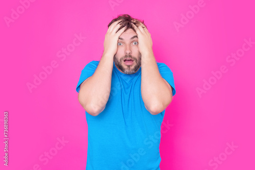 Portrait of shocked unshaven caucasian man afraid and shocked with surprise expression, fear and excited face. Emotion people. Shocked man with great disbelief, expresses surprisment and astonishment. photo