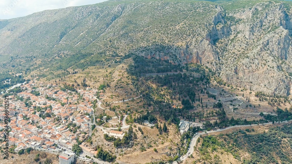 Delphi, Greece. The ruins of the ancient city of Delphi and the modern city. Sunny weather, Summer, Aerial View