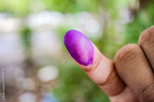 a picture of a man's hand. The ink on a man's finger was obtained after voting during the regional elections (pilkada) in Semarang, Indonesia photo