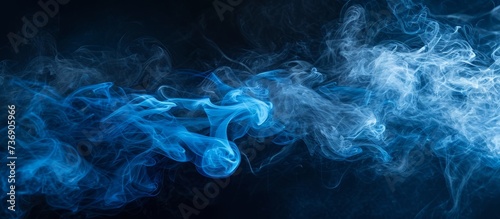 An artistic closeup of electric blue smoke resembling a geological phenomenon on a black background, creating a mesmerizing pattern in space