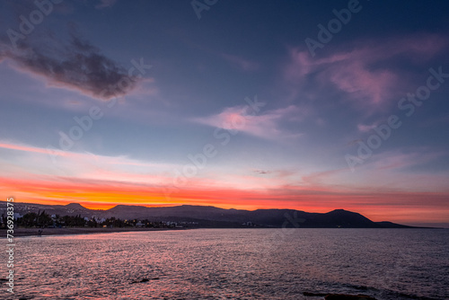 View of the Sunset at Chrysochou Bay as seen from Latsi village harbor, located by the sea, near Neo Chorio village, Akamas Peninsula, Cyprus 