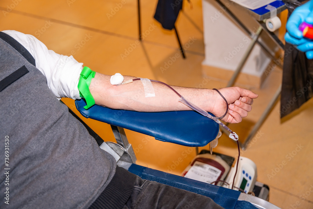 Man resting while donating blood in a center